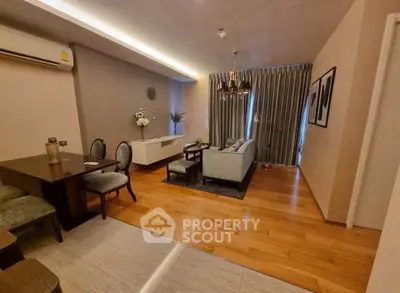 Elegant living room with modern decor and wooden flooring in a cozy apartment.