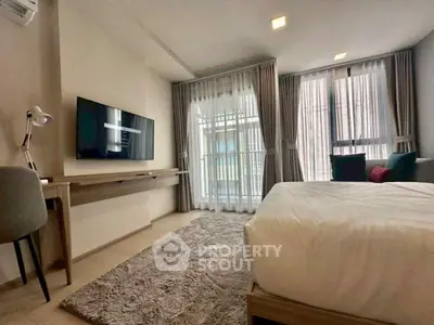 Modern bedroom with stylish decor and large windows for natural light.