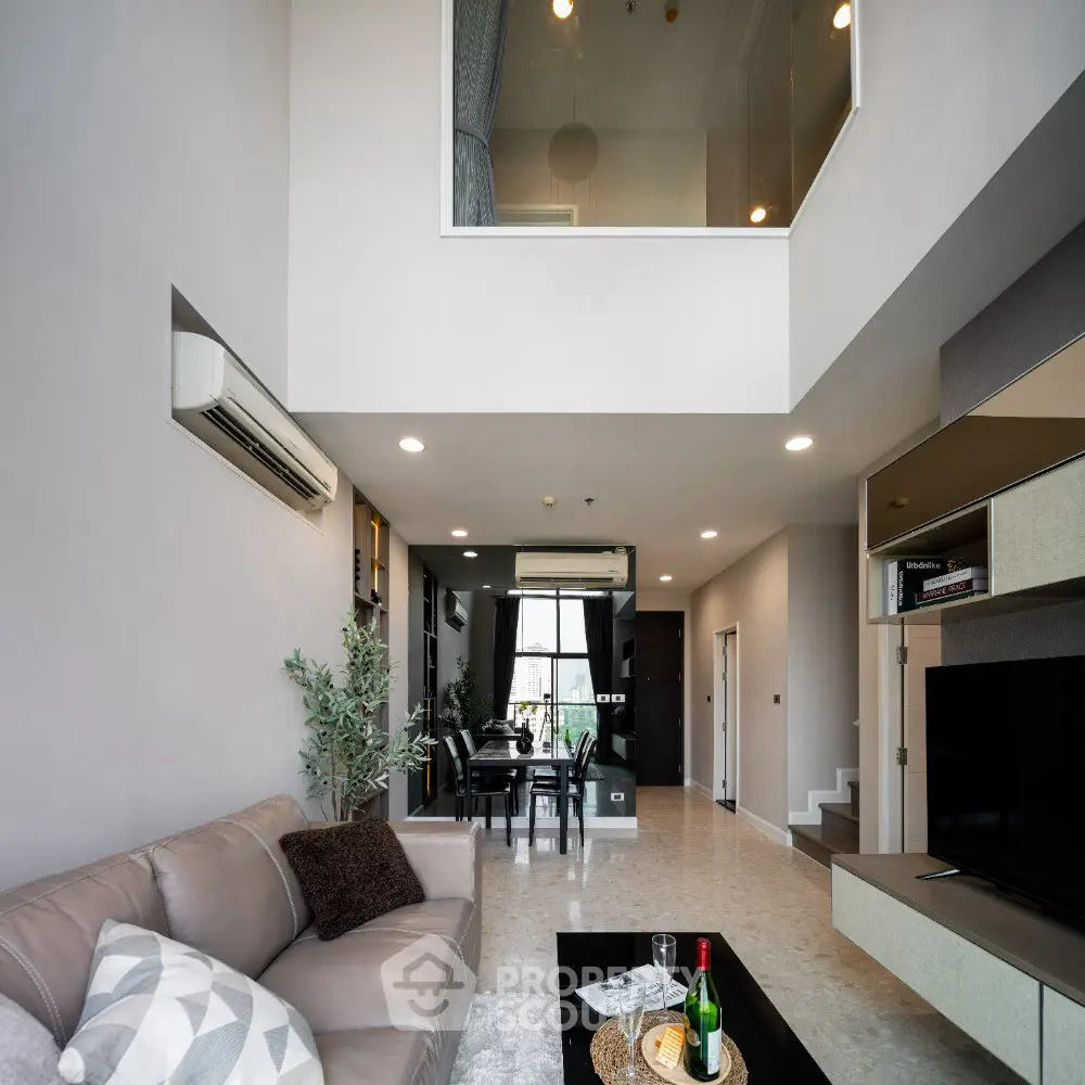 Spacious modern living room with high ceiling and elegant decor