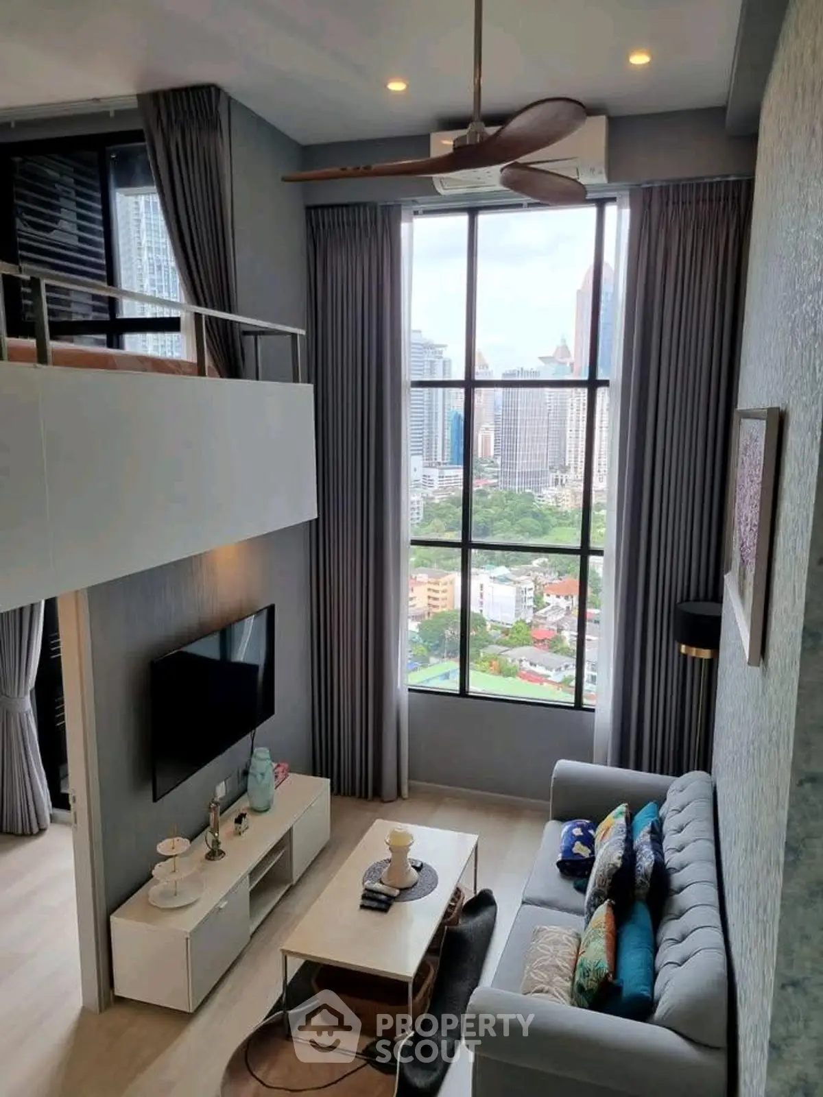 Modern loft apartment with high ceilings and city view, featuring stylish living room and mezzanine.