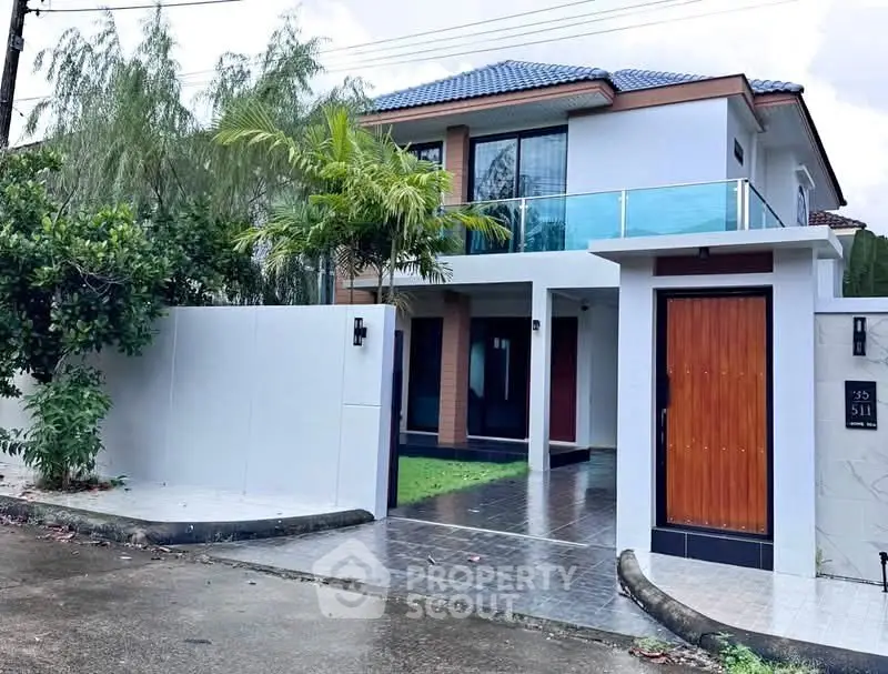 Modern two-story house with sleek design and spacious entrance in a serene neighborhood.