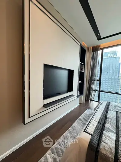 Luxurious bedroom with modern TV setup and stunning city view