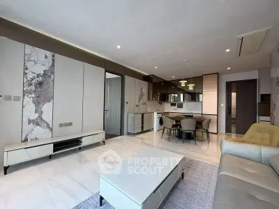 Modern open-plan living room with sleek kitchen and stylish furnishings