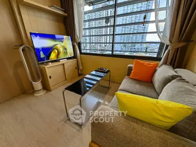 Modern living room with city view, stylish furniture, and large window for natural light.
