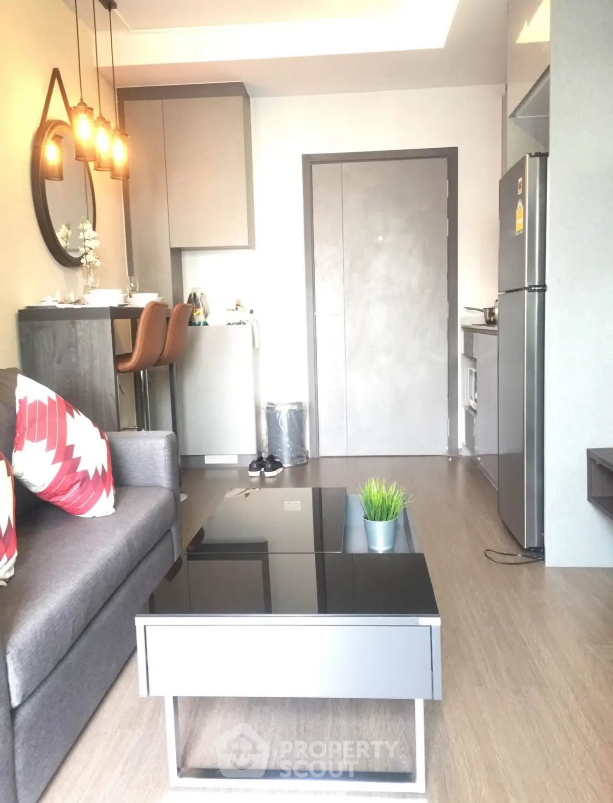 Modern living room with sleek furniture and stylish lighting in a cozy apartment.