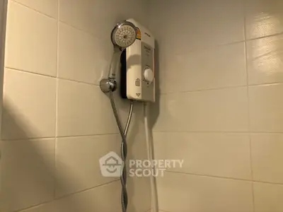Modern bathroom with sleek shower unit and tiled walls, perfect for a contemporary home.