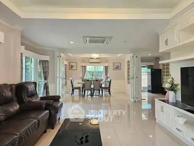 Spacious open-plan living and dining area with elegant furnishings and natural light.