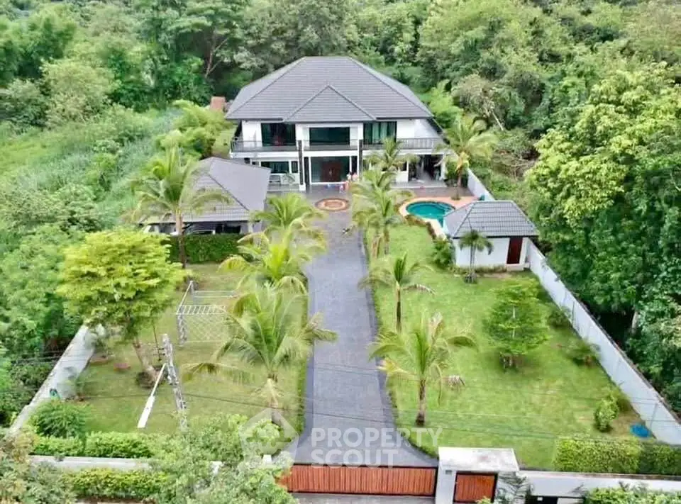 Luxurious villa with lush garden and private pool in serene setting
