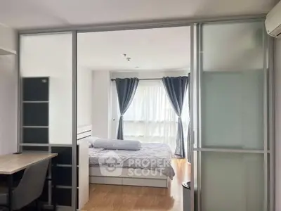 Modern bedroom with sliding glass doors and natural light