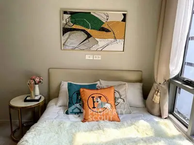 Chic bedroom with stylish decor and natural light, perfect for modern living.