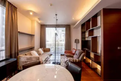 Spacious living room with modern furniture and large windows in a stylish apartment.
