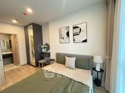 Modern bedroom with ensuite bathroom, stylish decor, and natural light.