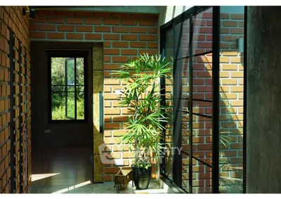 Modern brick interior with large windows and indoor plant