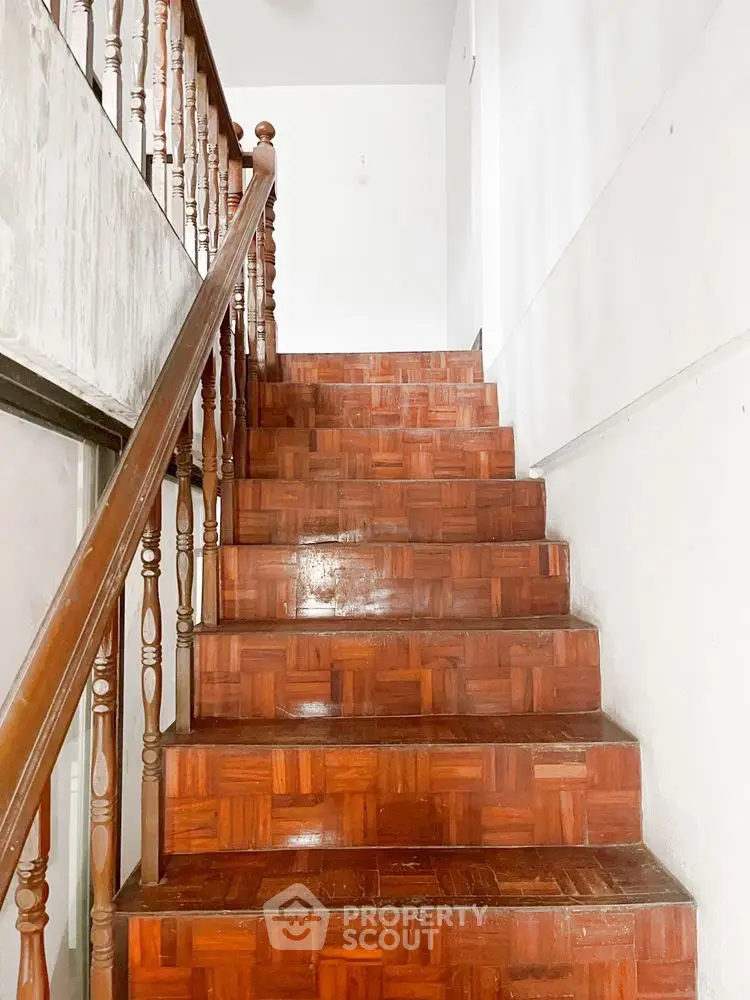 Charming wooden staircase with elegant railing in a bright interior space