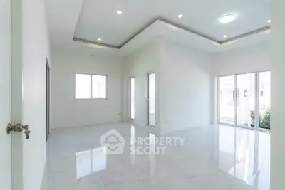 Spacious modern living room with large windows and elegant ceiling design