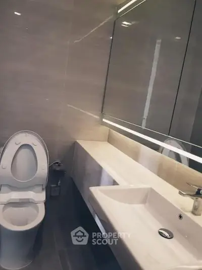 Modern bathroom with sleek design and elegant fixtures in a contemporary real estate property.