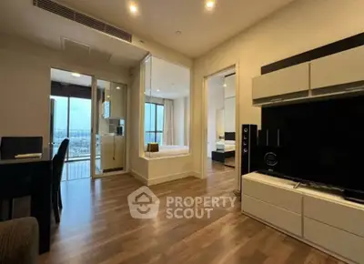 Modern living room with wooden flooring and open layout in a high-rise apartment.