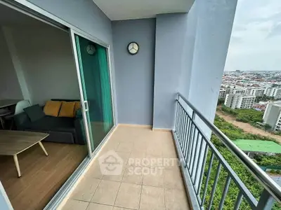 Spacious balcony with city view and cozy interior glimpse, perfect for urban living.