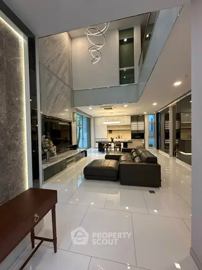 Luxurious modern living room with high ceilings and open kitchen layout