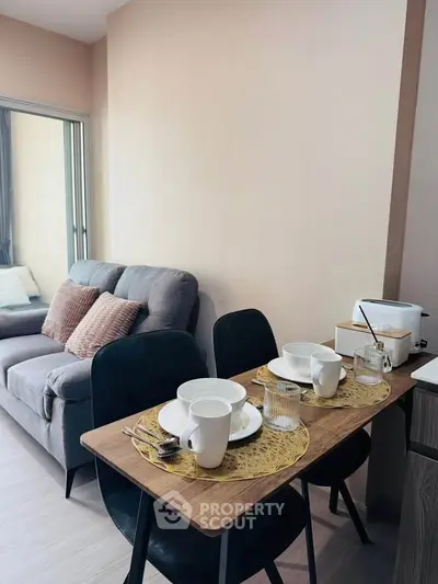 Cozy living room with dining area, featuring modern furniture and stylish decor.