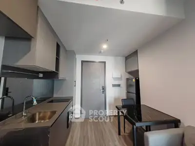 Modern kitchen with sleek design and dining area in contemporary apartment
