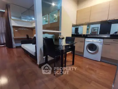 Modern apartment interior with open kitchen and washing machine
