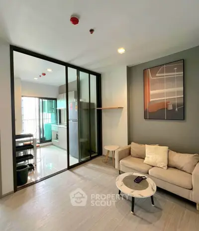 Modern living room with open kitchen and stylish decor in a bright apartment.