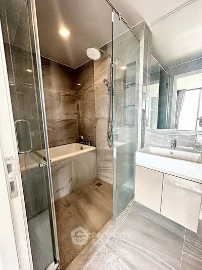 Luxurious modern bathroom with glass shower and sleek fixtures