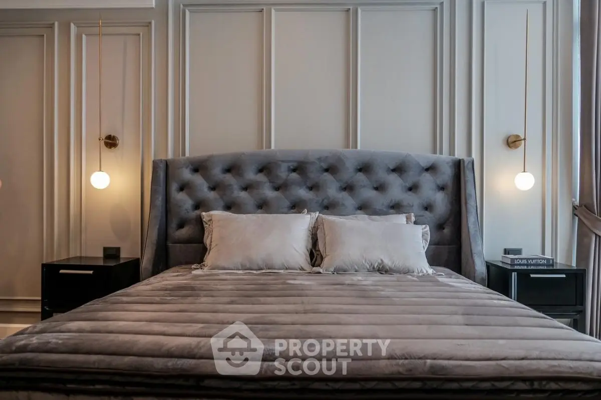 Luxurious bedroom with elegant tufted headboard and modern lighting