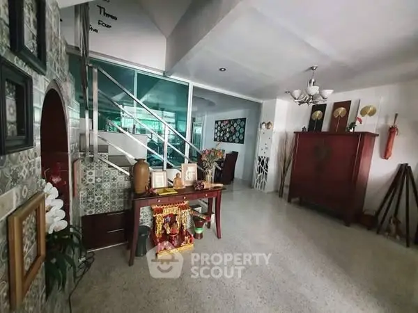 Spacious living area with modern decor and unique staircase design