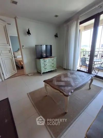 Charming living room with elegant furniture and balcony access