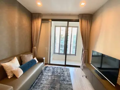 Modern living room with cozy sofa, stylish decor, and balcony view in a chic apartment.
