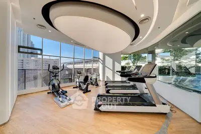 Modern gym with state-of-the-art equipment and city view, perfect for fitness enthusiasts.