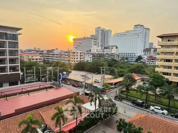 Stunning cityscape view from a high-rise building at sunset, showcasing urban living.