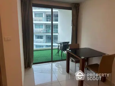 Modern apartment dining area with balcony view and stylish furniture