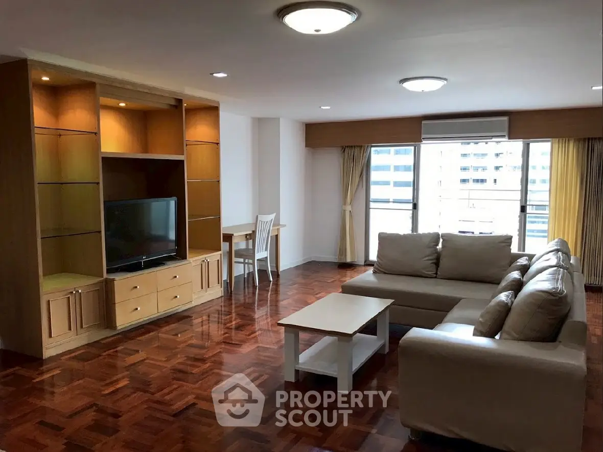 Spacious living room with modern furniture and city view, perfect for relaxation and entertainment.
