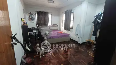 Cozy bedroom with wooden flooring and natural light