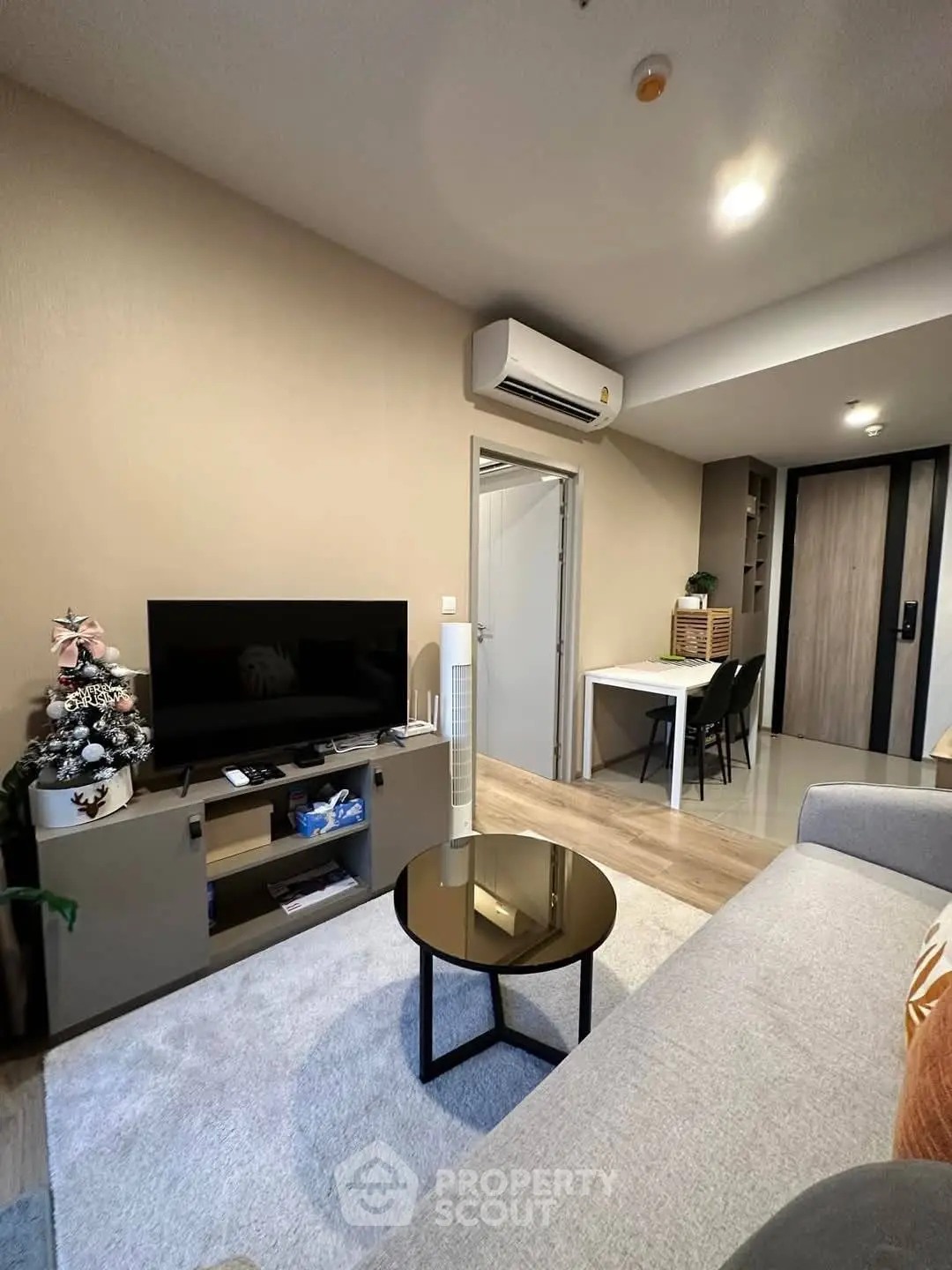 Modern living room with sleek furniture and air conditioning, perfect for cozy urban living.