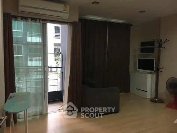 Cozy living room with balcony access in modern apartment