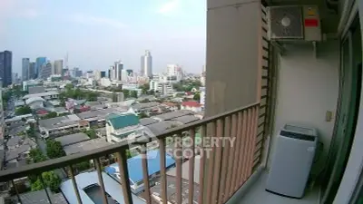 Stunning city view from a high-rise balcony with modern air conditioning unit.