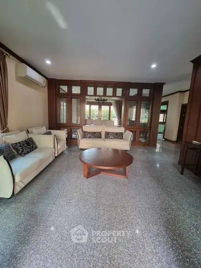Spacious living room with elegant sofas and large windows in a modern home