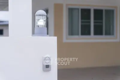 Modern exterior with stylish light fixture and window view