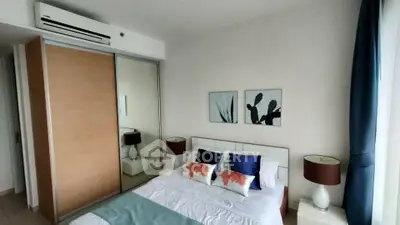 Modern bedroom with stylish decor and mirrored closet doors