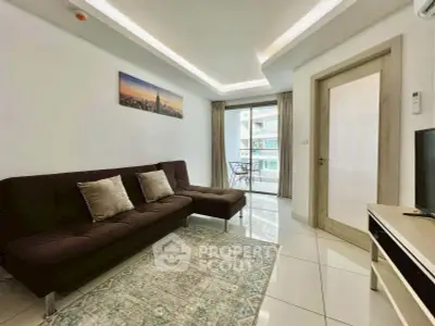 Modern living room with sleek design and balcony view in a high-rise apartment.