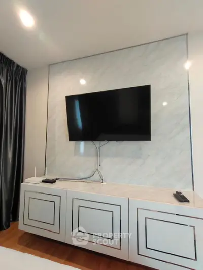 Modern living room with wall-mounted TV and elegant cabinetry