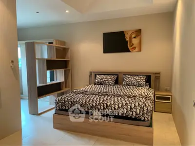 Spacious modern bedroom with stylish decor and ample natural light