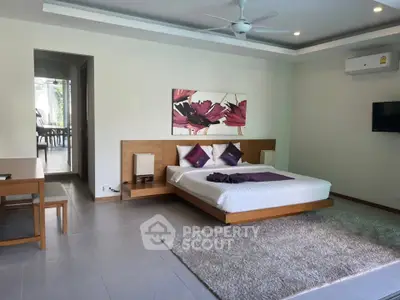 Spacious modern bedroom with elegant decor and natural light