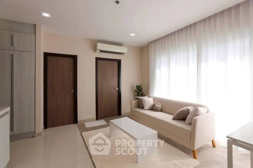 Modern living room with neutral tones and natural light