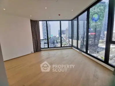 Spacious corner unit with floor-to-ceiling windows offering stunning city views in a modern high-rise building.