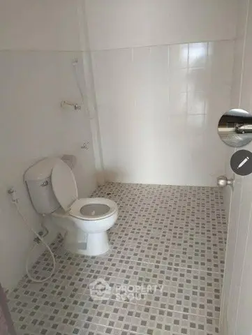 Spacious bathroom with modern fixtures and tiled flooring
